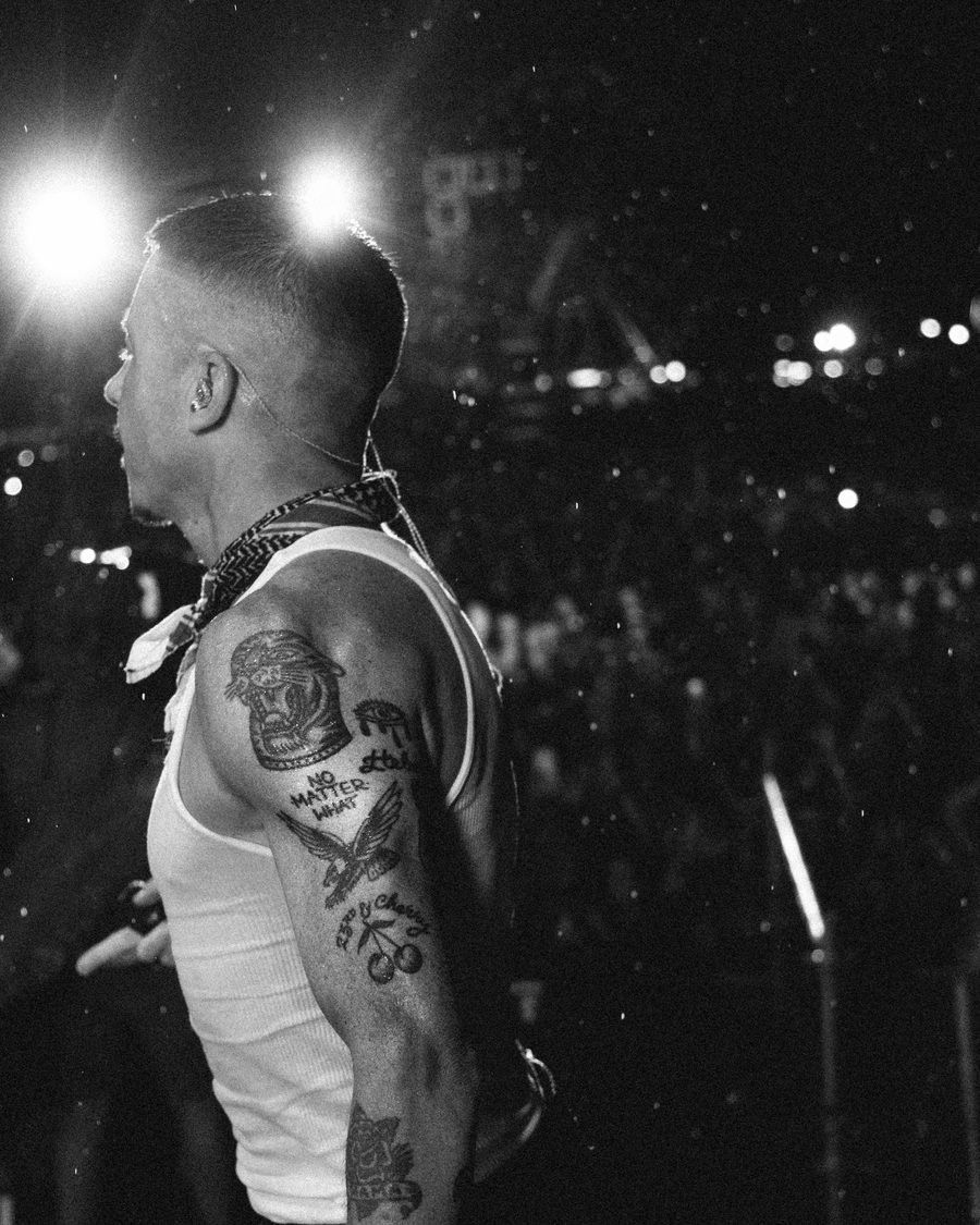Black and white photo of Macklemore on stage facing the crowd